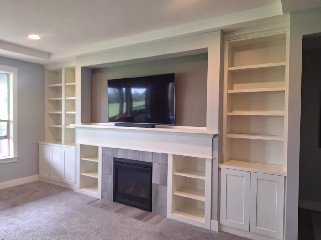Freshly painted living room with fireplace and built-in shelves