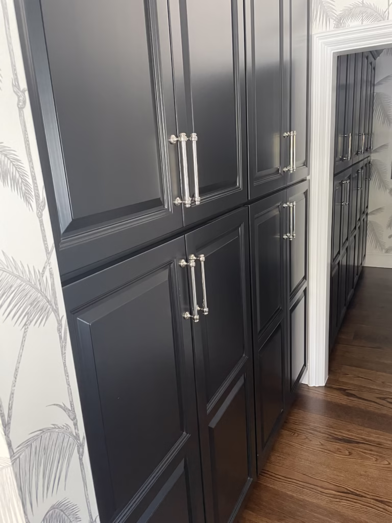 Navy blue painted cabinets with silver hardware