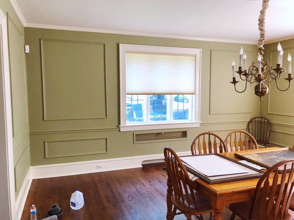 Dining room painted green with wainscoting