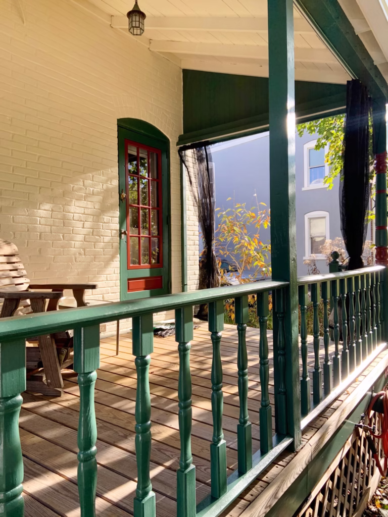 Porch with painted green railings and trim