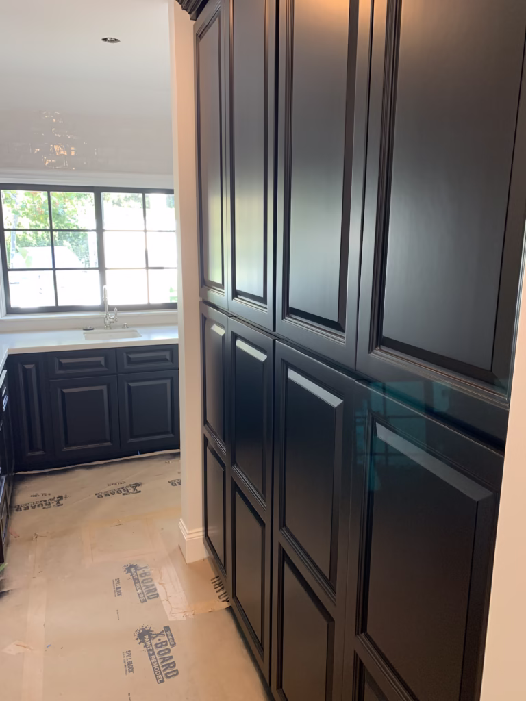 Cabinets prepped with floor protection for painting