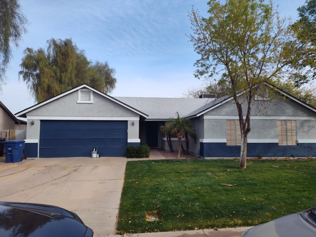 Single-story home exterior painted blue and gray