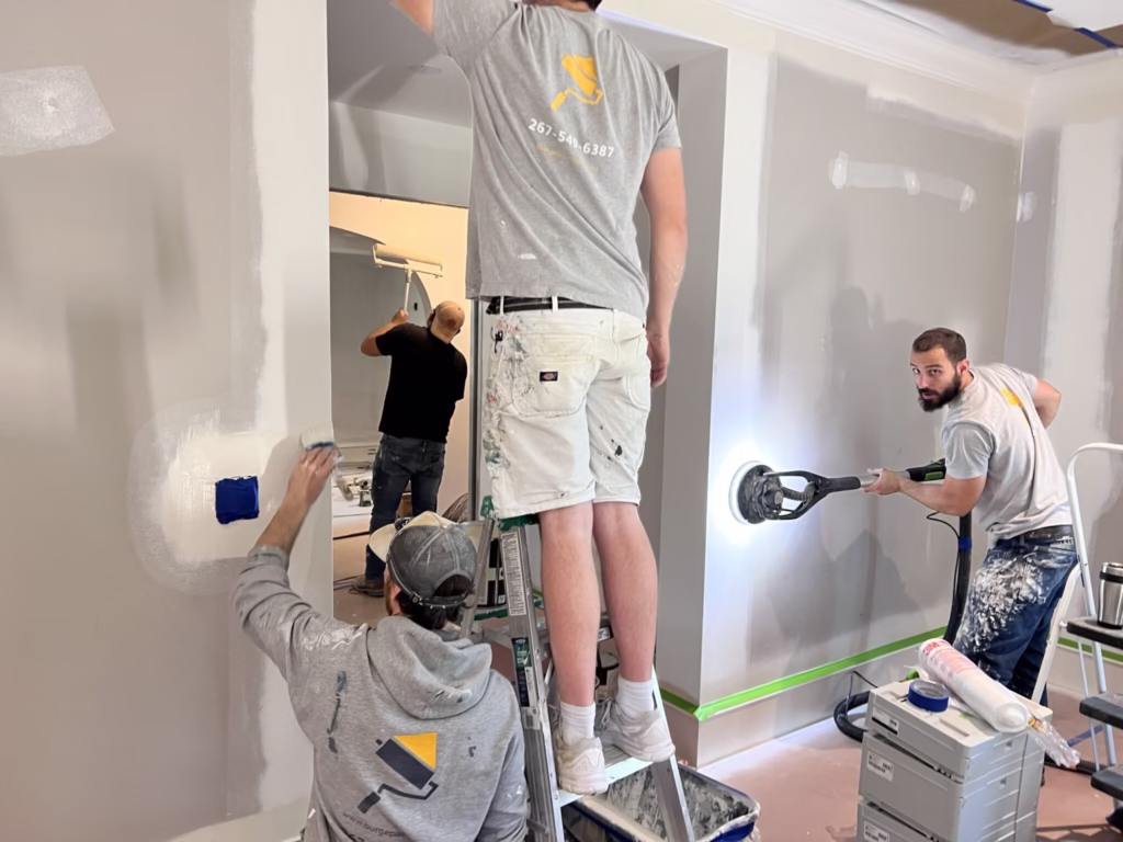 Signature Painting crew sanding and painting interior walls